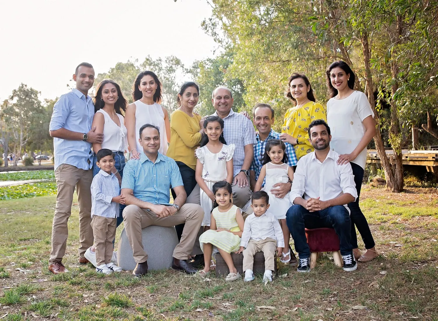 Big extended family group on the grass in a park