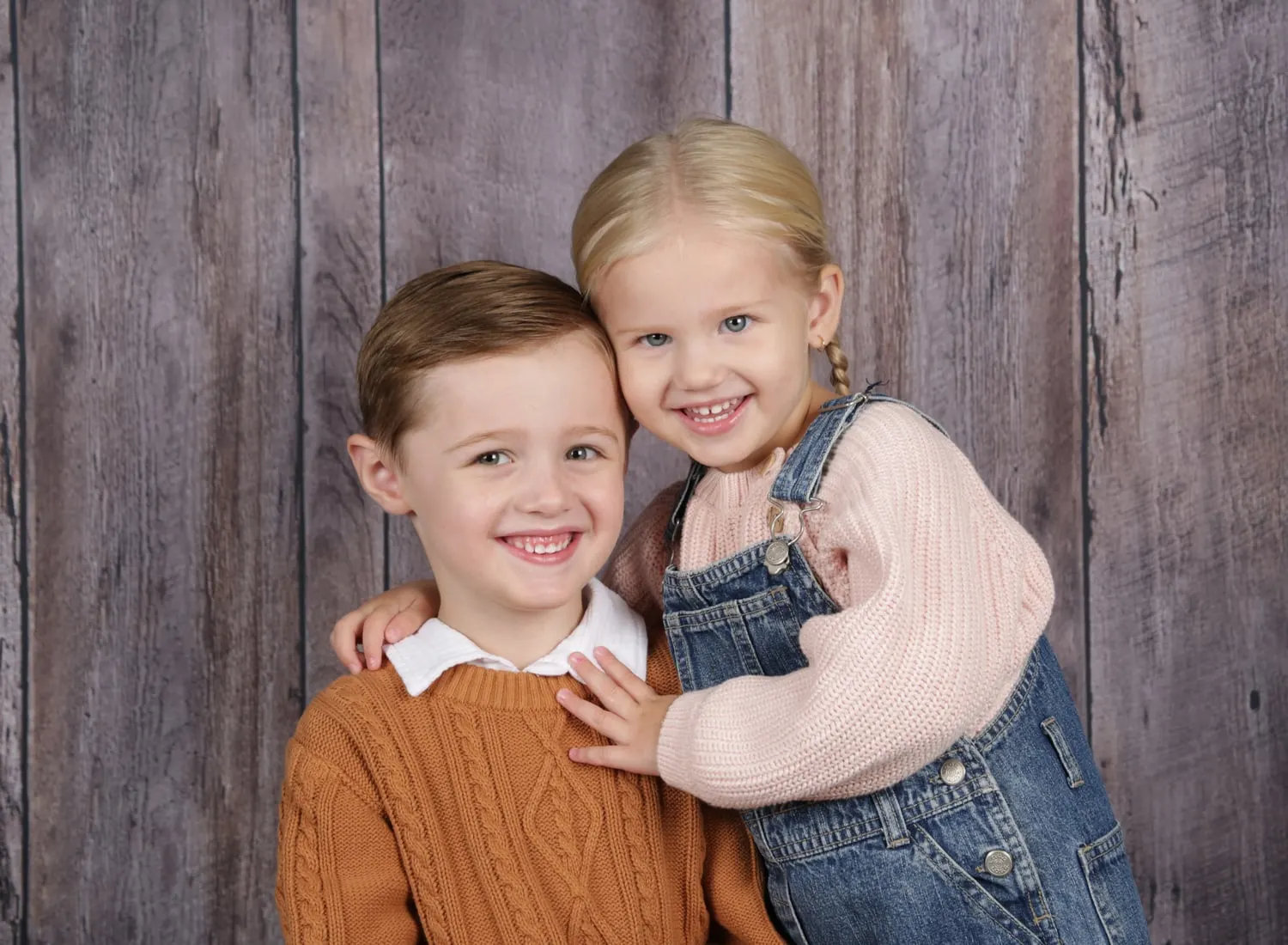 Brother and sister cuddling on photo day