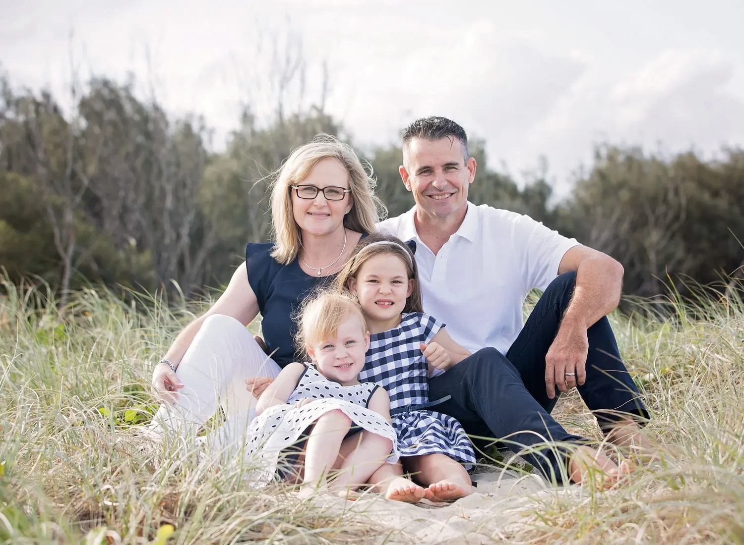 Couple with their two little girls in the dunes