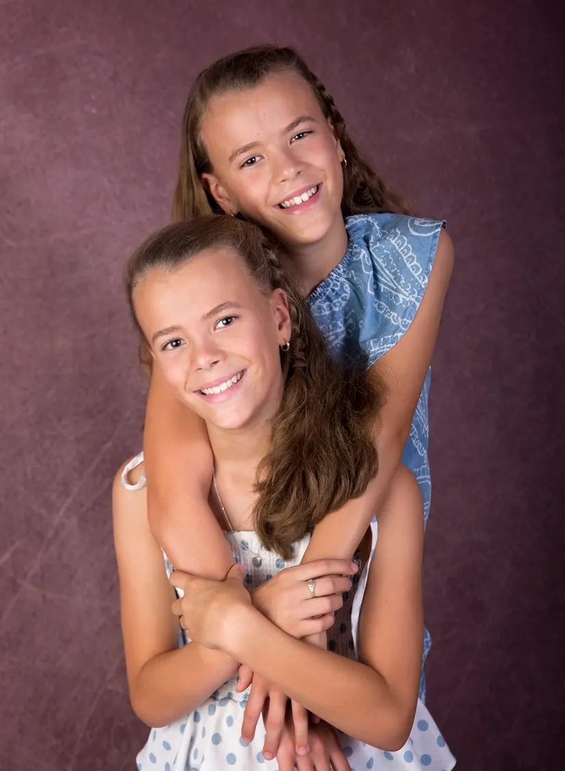 Two sisters hugging in the studio