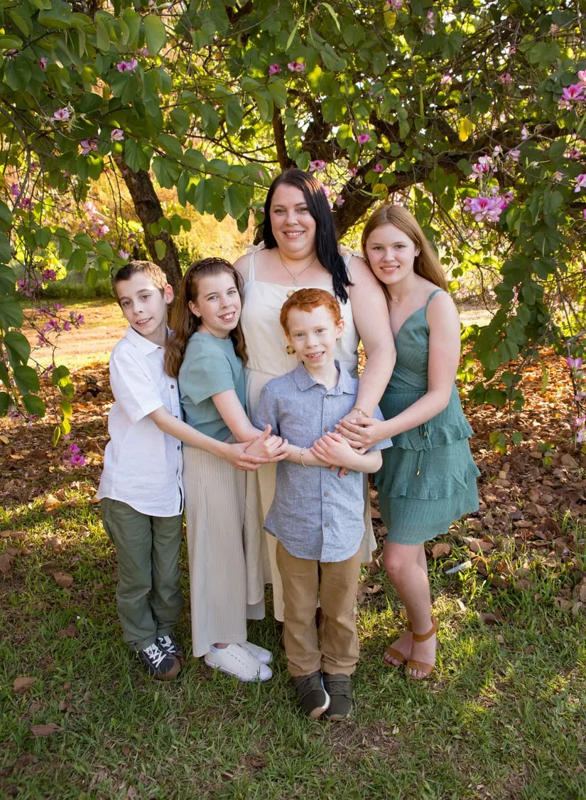 Mum with her four children under flowering trees