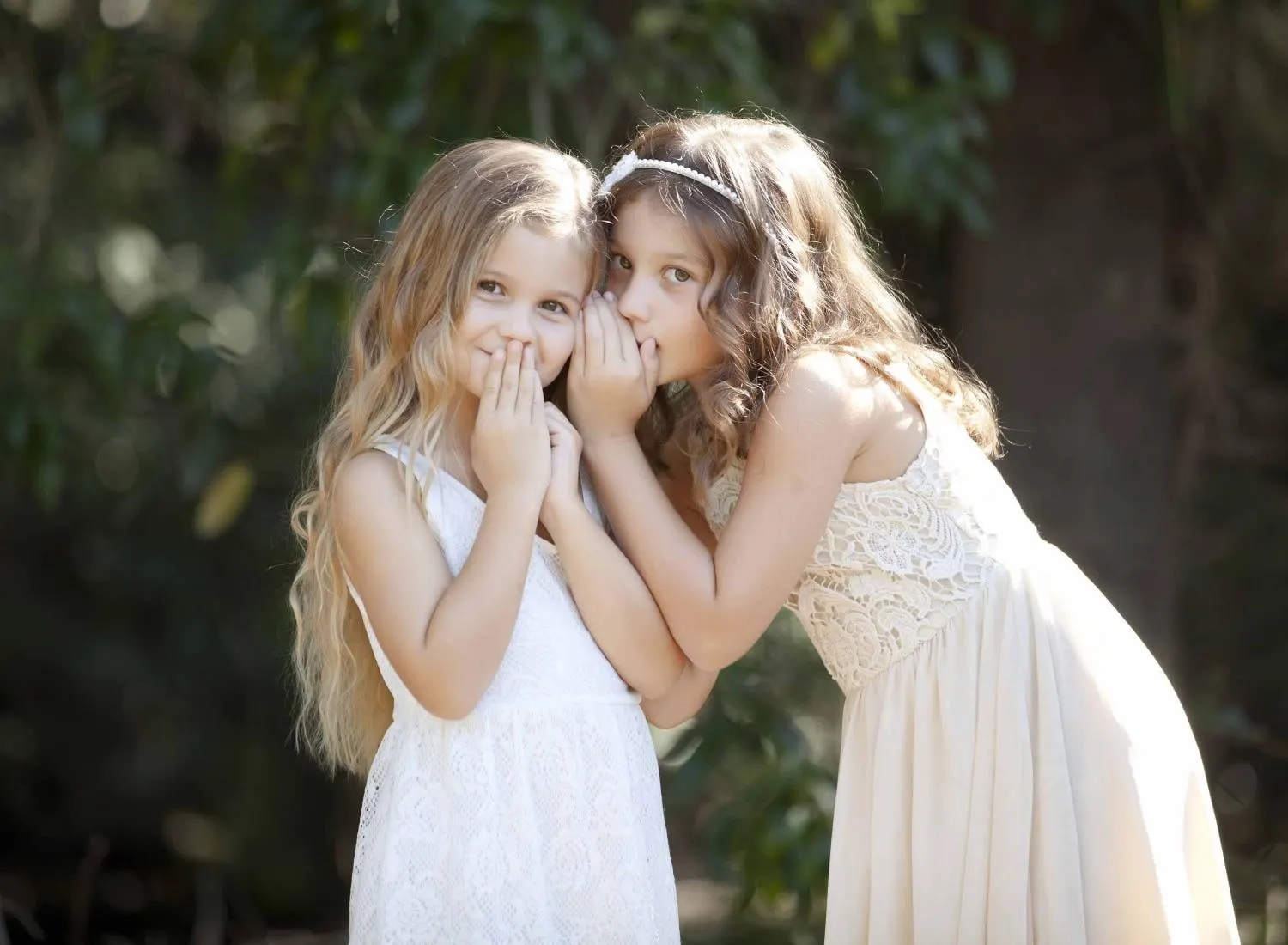 Two sisters sharing a secret in the garden